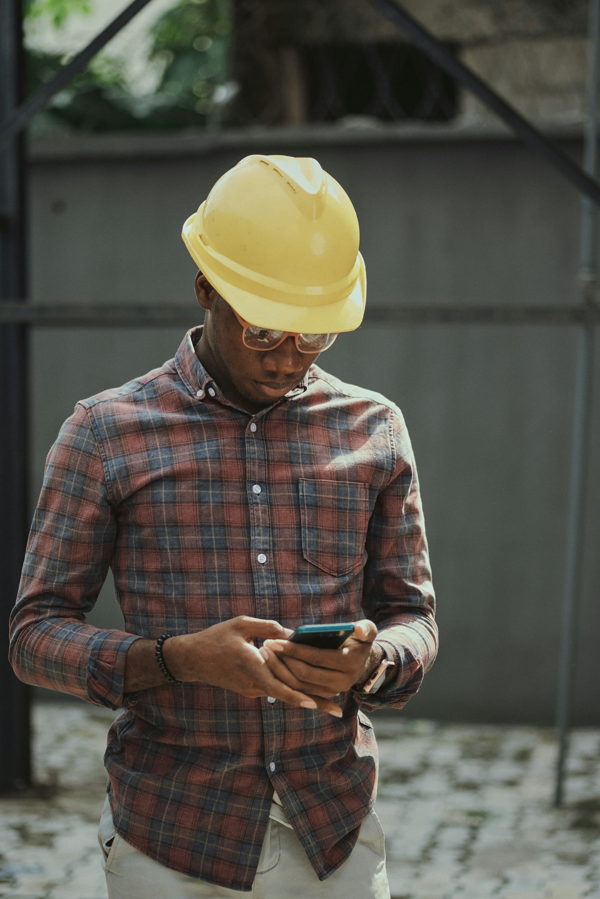 Contractor checking a phone in the field